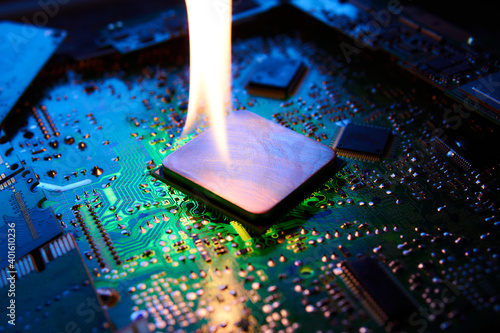 The flame is on the central processor that lies on the printed circuit board. Low-key photo.
