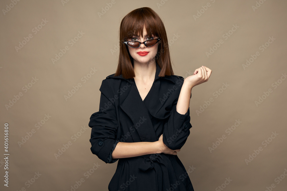 Sexy woman dark coat self-confidence having fun on an isolated background Sexy woman dark coat self-confidence having fun on an isolated background