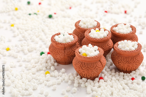 Indian festival makar sankranti concept : Tilgul in small bowl. Tilgul is a colourful sesame candy coated with sesame seeds; in Maharashtra people exchange tilgul on Sankranti photo