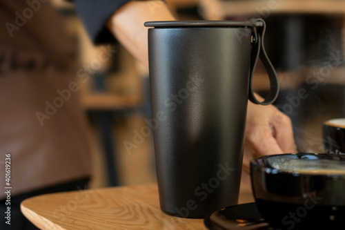 Hot coffee in cup for take away at coffee shop. Selective focus and free space for text. Coffee for take home in cafe, Protection form Virus Corona 19 ideas concept.