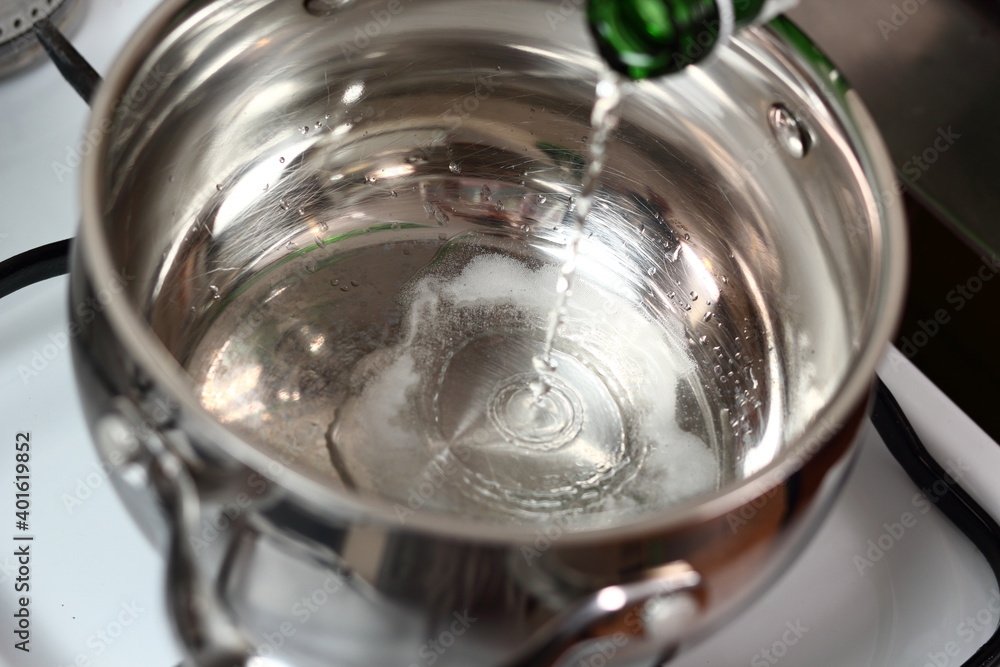Pouring sparkling wine into saucepan Pouring sparkling wine into saucepan