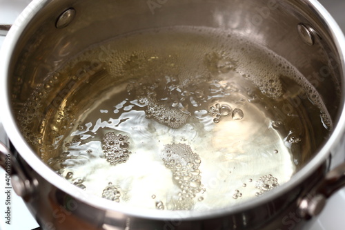 Boiling sparkling wine in saucepan