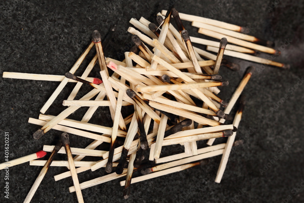 Heap of burnt matches on granite table Heap of burnt matches on granite table