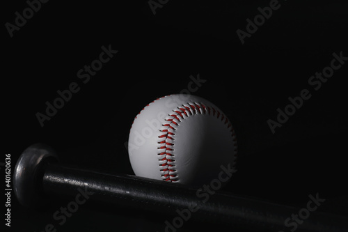 American traditional sports game. Baseball. Concept. Baseball ball and bats on a black table. photo