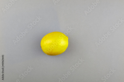 Lemon on a gray background. Pantone color of year 2021. Illuminating and Ultimate gray.