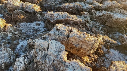 Close-up of rough ground with salt with Golden sunset light at Devils Golf course at Death Valley National Park, CA, USA. Slider left to right.