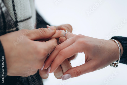 The guy puts a wedding ring on the girl's hand, offering to marry