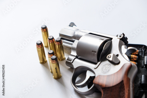 .44 magnum revolver gun with bullet on white background photo