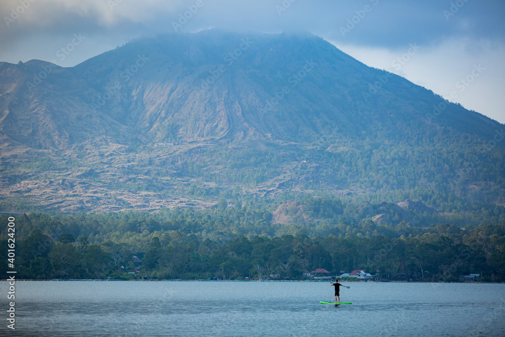 Fototapeta premium a man on the lake ride a sup board. high quality photo