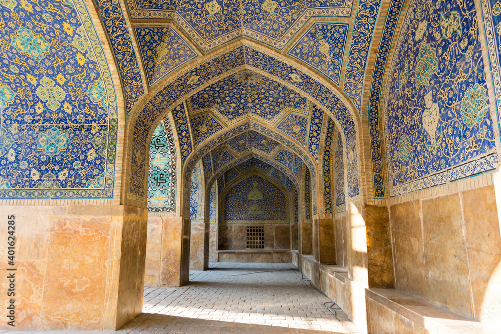 Arches of Historic buildings with persian blue tiles on the wall of Shah Mosque, situated on the south side of Naqsh-e Jahan Square  , an important historical site.