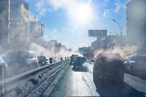 pollution from the exhaust of cars in the city in the winter. Smoke from cars on a cold winter day