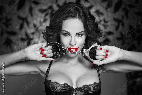 Samolepka Sexy woman holding handcuffs in nightclub black and white selective coloring