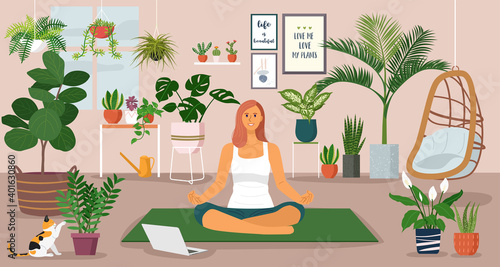 Stay at home concept, young woman having yoga lessons over a video call at home decorated with indoor plants