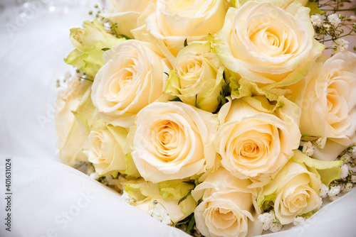 Bridal bouquet   wedding bouquet of white roses on white fabric  beautiful flowers 