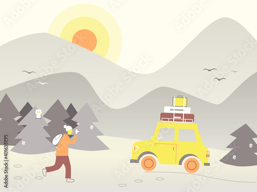tourist with a backpack photographs the sights of the mountain winter landscape