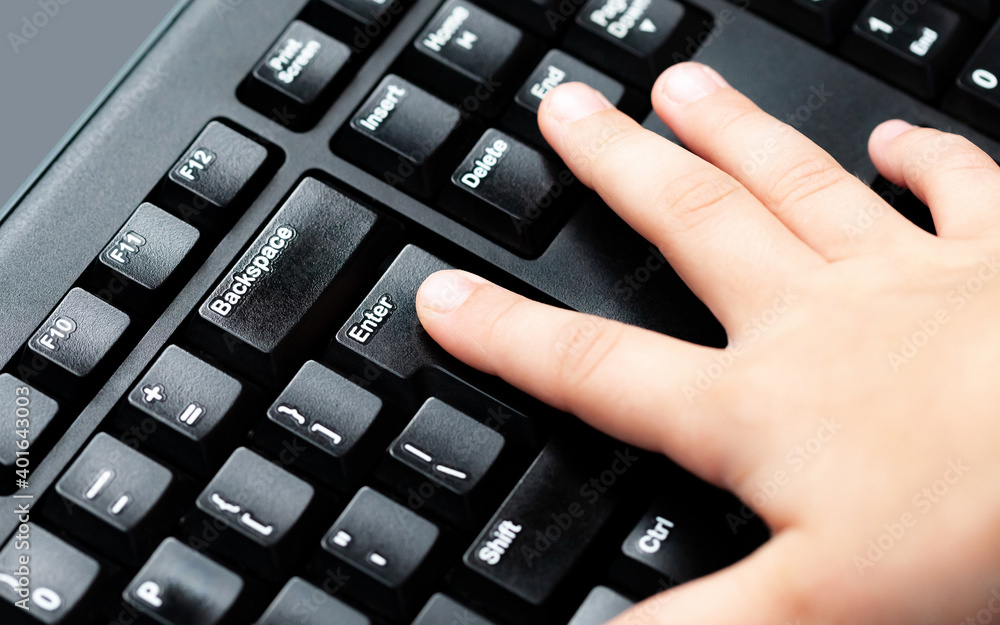 Child, little finger pressing enter key on desktop pc keyboard. Kids finger pushing enter button on computer keyboard closeup Children safety in the internet, chatting, parental guard abstract concept Child, little finger pressing enter key on desktop pc keyboard. Kids finger pushing enter button on computer keyboard closeup Children safety in the internet, chatting, parental guard abstract concept