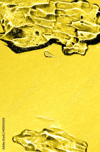 Hyaluronic acid gel in trendy color of 2021 year illuminating yellow. Textured background with oxygen bubbles