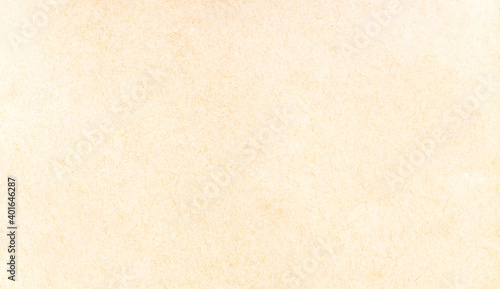 Old antique stylish yellowed parchment, worn paper design abstract creative background texture, full frame, copy space. Simple dated yellowish empty paper page structure, surface top view, closeup