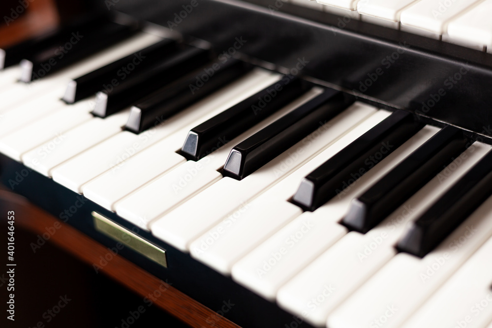 Simple pipe organ instrument keyboard closeup. Organ keys seen from up close, shallow depth of field. Sacral religious music, classical music concert event minimal background abstract concept