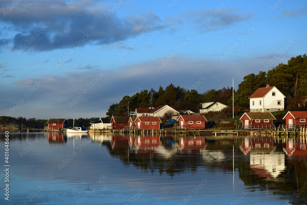 Boathouses with water reflection