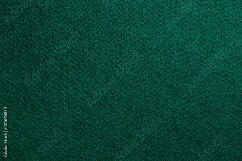 Texture of a green mat of poker cards. 