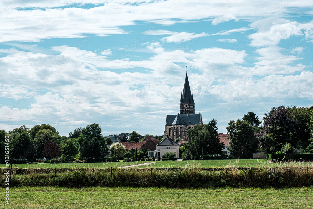 View of dutch white little town Thorn, province of Limburg, Netherlands. The Saint Michaels church or Abbey Church of 'Thorn', Roman Catholic church from the 14th century.