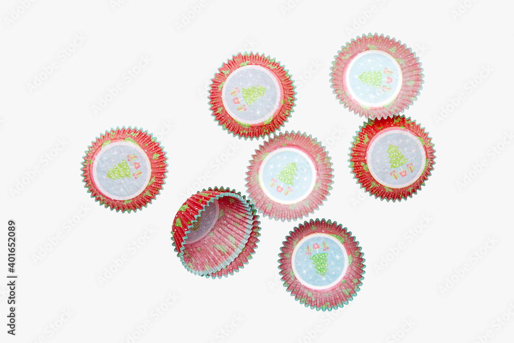 Paper baking pan for muffins and muffins with christmas pattern on white background, object photography
Paper baking pan for muffins and muffins with christmas pattern on white background, object photography