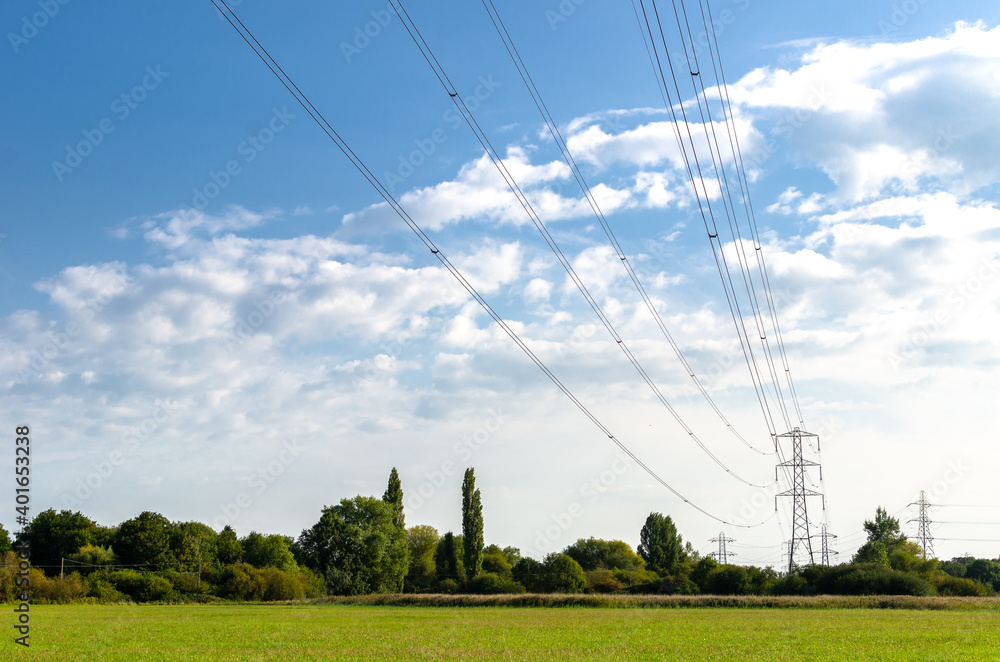 Electricity power lines lines running over a field at Chertsey, England