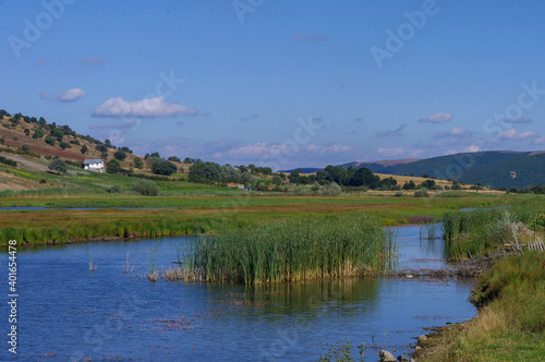 View of the hill, reeds and lake.