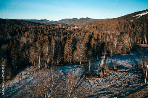 Drone photo shot from the sky. Countryside just outside of Oslo, Norway. Fields and wood mixed together. 