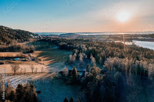 Drone photo shot from the sky. Countryside just outside of Oslo, Norway. Fields and wood mixed together.  photo