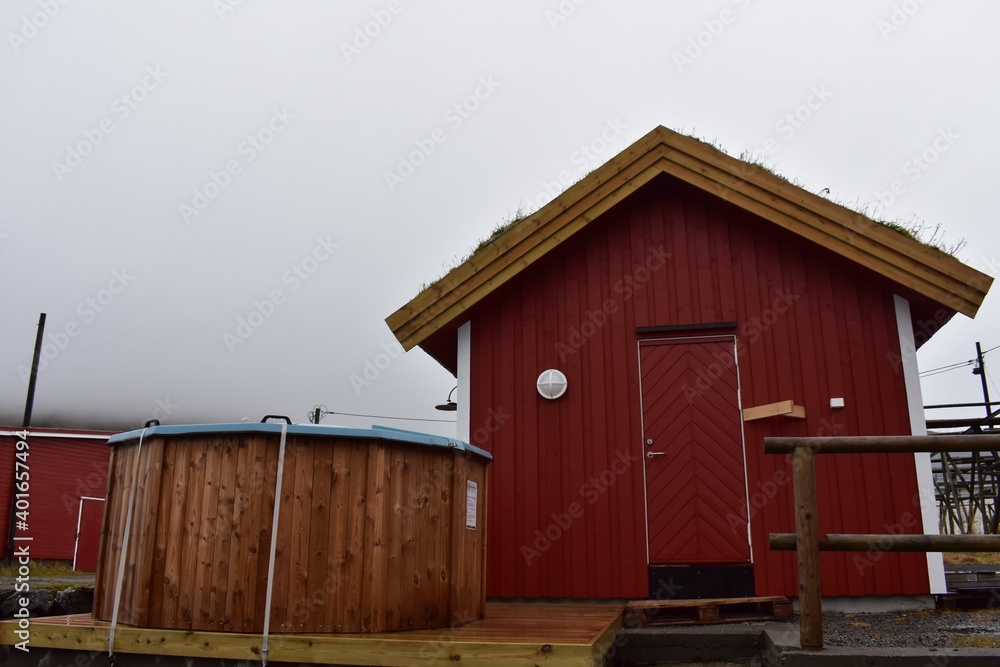 the rorbuer or fisherman house adapt to hotel made from red wooden and brown wooden bath tub with white sky at lofoten norway the rorbuer or fisherman house adapt to hotel made from red wooden and brown wooden bath tub with white sky at lofoten norway