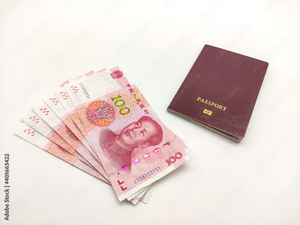 Stack of Chinese yuan's banknotes and passport on a white background close up Stack of Chinese yuan's banknotes and passport on a white background close up
