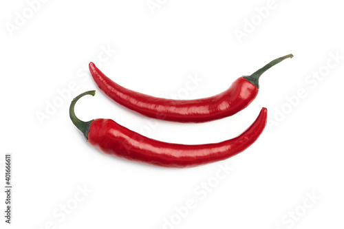 2 red chili peppers on a white plate, white clean background, chili peppers, hot peppers, bio products