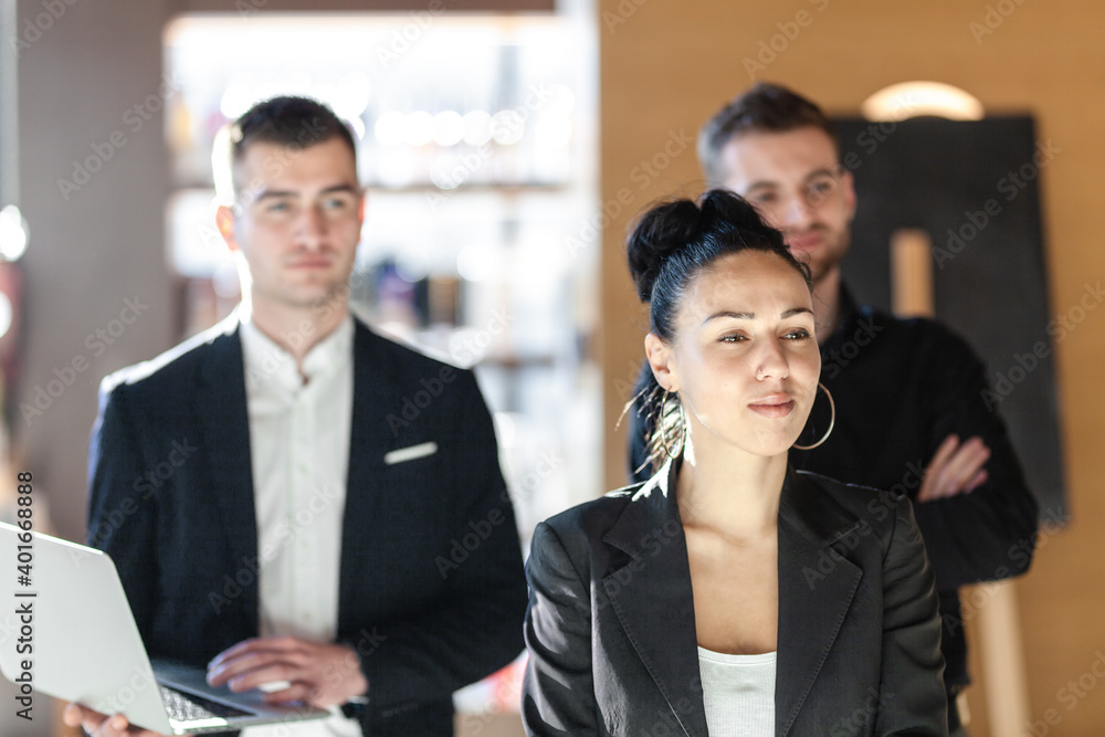 Team of three business people looking forward.