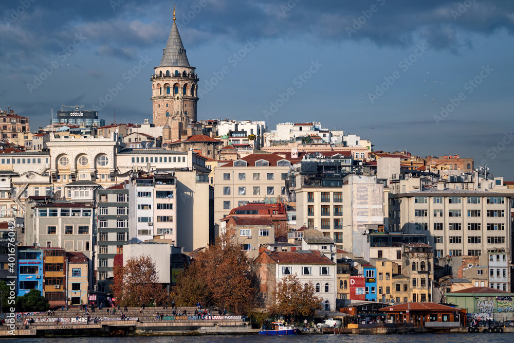 Landscape view on the Istanbul embankment and Galata Tower under blue autumn sky