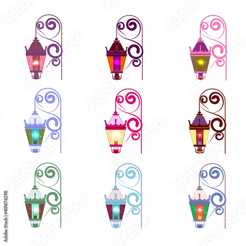 Set of multicolored vintage outdoor pendant lights, glowing. With curled cast iron wall mount.