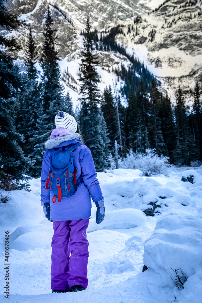 A child standing at a viewpoint on the Mount Black Prince winter hiking trail in the Canadian Rockies near Banff Alberta Canada. A child standing at a viewpoint on the Mount Black Prince winter hiking trail in the Canadian Rockies near Banff Alberta Canada.