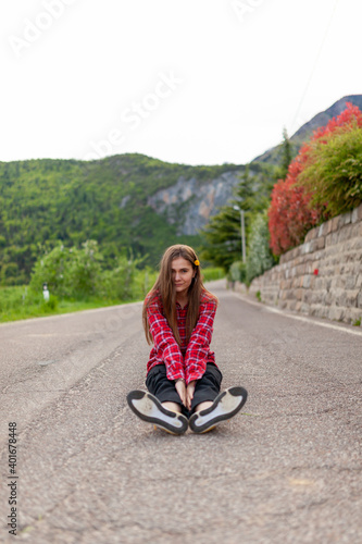 girl laying on the mountain road. flower in the hair