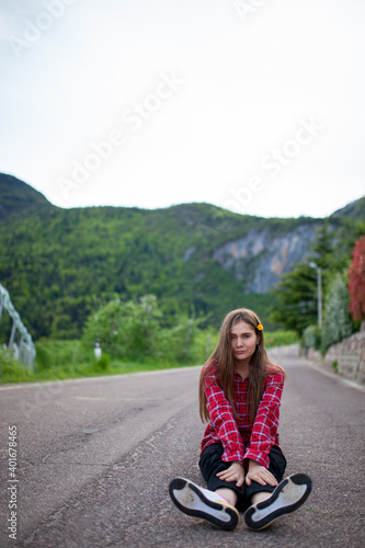 girl laying on the mountain road. flower in the hair