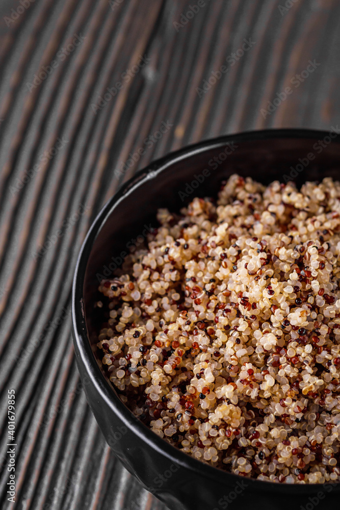 bowl of healthy quinoa on a dark wooden rustic background bowl of healthy quinoa on a dark wooden rustic background