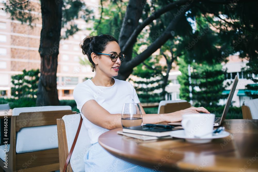 Young freelancer surfing internet on street