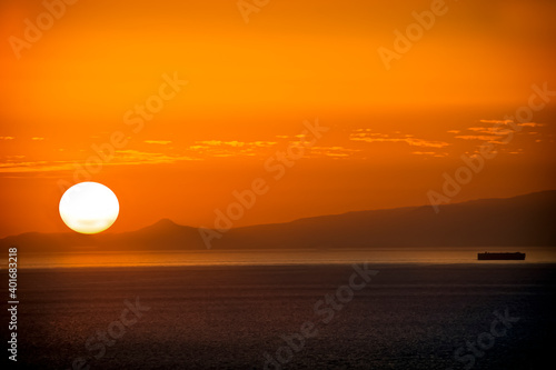  Sunrise with a sailing boat in Tenerife Canary Islands.