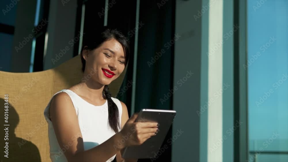 Pretty mixed race business woman working at laptop at modern lounge. Beautiful successful lady using application on small computer and sitting at lobby or office. Concept of distant work and freelance Pretty mixed race business woman working at laptop at modern lounge. Beautiful successful lady using application on small computer and sitting at lobby or office. Concept of distant work and freelance