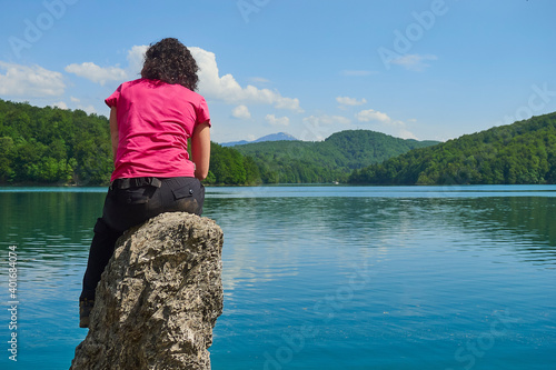 Young friends boys and girls walk in the mountains, along paths trought rocks and nature. 
