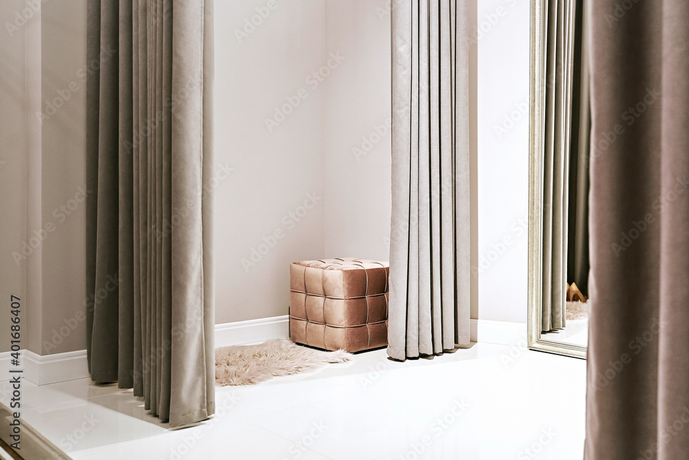 Fitting room with mirror in a dress rental service or boutique showroom