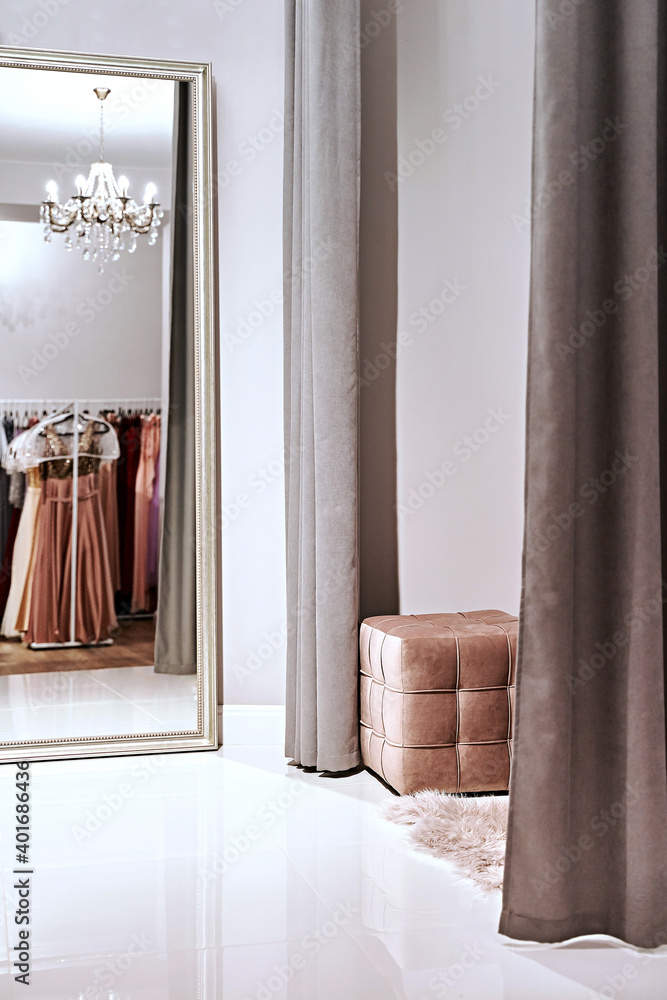Fitting room with mirror in a dress rental service or boutique showroom