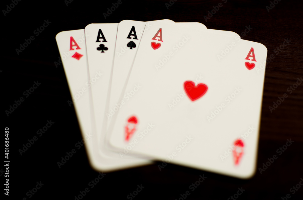Aces poker on dark wood table Aces poker on dark wood table