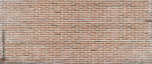 Panorama of an old red brick wall as a background or texture. Red brick wall. Texture of old dark brown and red brick wall panoramic backgorund.