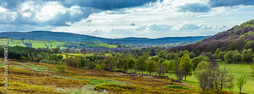 Heathland merges into a landscape of trees towards the town of Glossop, UK © Nicola